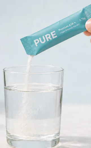 Pouring a sachet into a glass of water